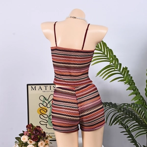 Detail of colorful striped knitted two-piece set with crop top and mini skirt on a mannequin