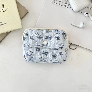 Quilted light blue pouch with jellyfish patterns shown in a clean lifestyle desktop setup