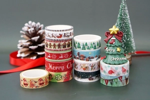 Detail of Christmas washi tape set featuring gingerbread and reindeer patterns on grey background
