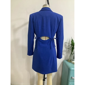 Detail of royal blue blazer dress featuring an open back cutout and lace-up bow ties