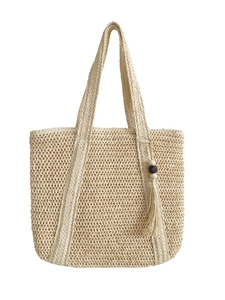 Large beige woven straw tote bag with double handles and wooden bead tassel for beach holidays