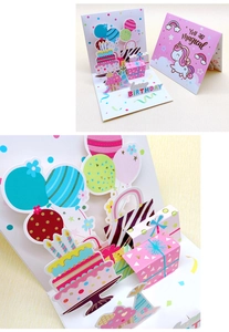 Detailed view of a 3D birthday card featuring colorful balloons and a unicorn small note