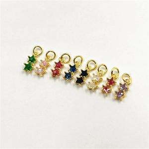 Detailed view of colorful zircon star pendants with gold plating for DIY jewelry making