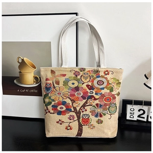 Ethnic owl canvas tote bag featuring colorful embroidery and durable shoulder straps
