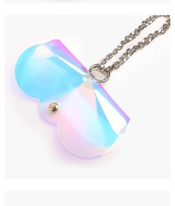 Detailed macro of holographic laser eyewear pouch with gold snap and metal chain link