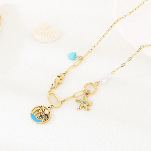 Detail of gold ocean necklace with starfish, seahorse, and turquoise heart charms