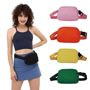 Close-up of waterproof nylon waist bags in five colors with adjustable straps and buckles