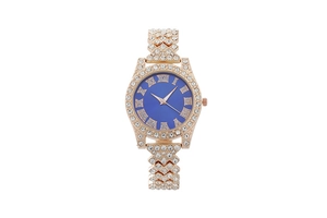 Detail of rose gold quartz watch featuring a crystal-studded bezel and navy blue dial