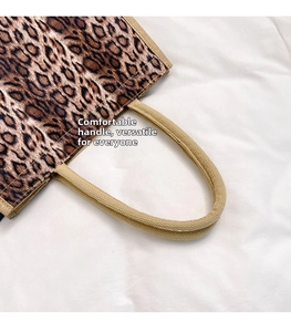 Close-up of comfortable woven handles on a leopard print linen tote bag detail