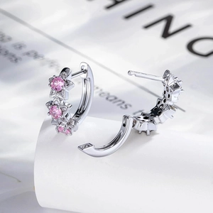 Silver hoop earrings featuring pink star zircon accents and a minimalist design