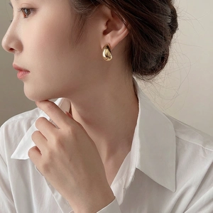 Minimalist gold C-shaped bean stud earrings with polished metallic finish for women