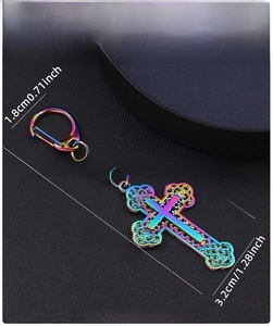 Macro detail of rainbow plated cross keychain with intricate embossed hollow textures