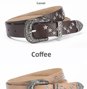 Close-up of vintage brown PU leather belts with star studs and engraved western buckles