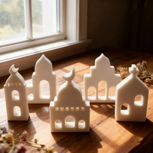 Detailed view of 5-piece castle silhouette silicone molds on a natural wood surface