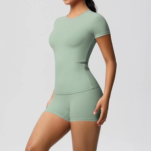 Detail of high-stretch mint green yoga set featuring a slim-fit short sleeve top and shorts