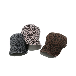 Detailed view of distressed leopard print baseball caps with vintage frayed edge brims