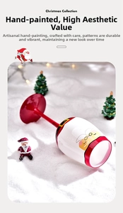 Macro shot of hand-painted Santa Claus pattern on a creative festive red wine glass