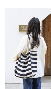Macro shot of large capacity canvas tote bag with classic black and white wide stripes