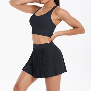Close-up of black high-waisted pleated tennis skirt and elastic moisture-wicking fabric