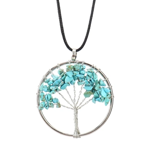 Detail of silver wire-wrapped tree of life pendant with blue crystal chips