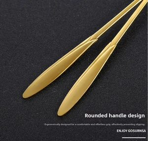 Close-up of a rounded golden stainless steel spoon handle with ergonomic design