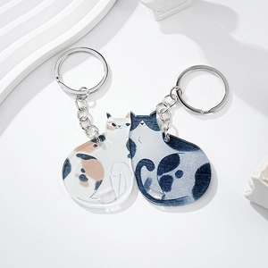 Detail of creative cat couple keychains in acrylic with metal rings and chains
