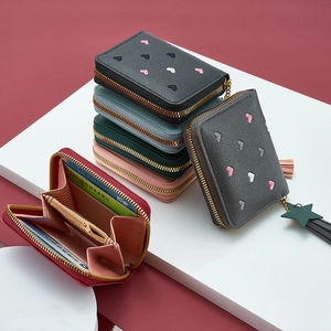 Detail of the multi-slot interior organ design and colorful tassel zip card holder