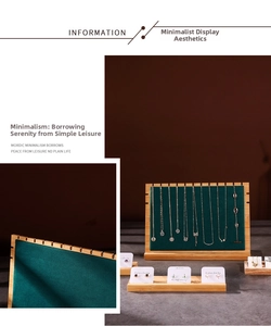 Detailed view of dark green velvet and bamboo necklace display board with multiple slots