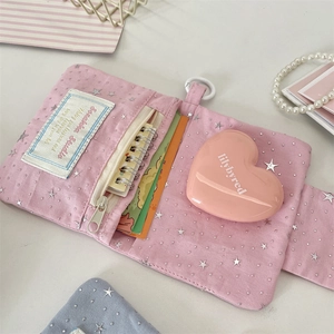 Detailed view of pink fabric wallet with silver star prints and functional card slots
