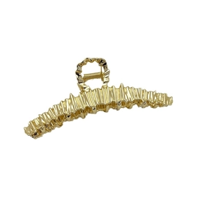 Minimalist irregular gold shark hair clip with textured crinkle finish on white background