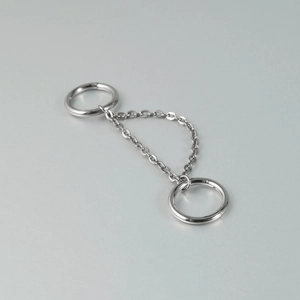 Detailed view of silver G23 titanium double chain nose stud with sparkling cubic zirconia