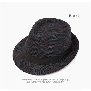 Detail of a black plaid fedora hat with red-grey glen check pattern and matte band