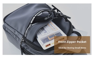 Close-up of front zipper pocket on a waterproof nylon chest bag holding digital accessories