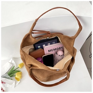 Top view of large brown suede tote bag showing spacious interior for tablets and books