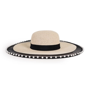 Close-up of woven straw hat with elegant black mesh trim and white pearl bead accents