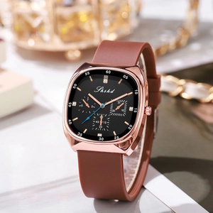 Detail of rose gold square watch with brown silicone strap and triple sub-dial design
