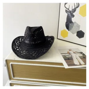 Detail of black woven straw cowboy hat with hollow breathable patterns and wide brim
