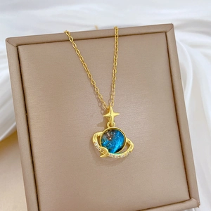 Star and moon necklace with blue planet pendant and cubic zirconia in gold plated steel