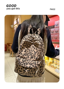 Detail view of leopard print corduroy backpack worn by model in a daily casual setting