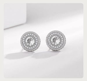 Macro shot of silver hip hop stud earrings featuring a large zircon stone and micro-pave trim