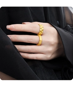 Detailed view of matte and textured gold S925 sterling silver rings on a model hand