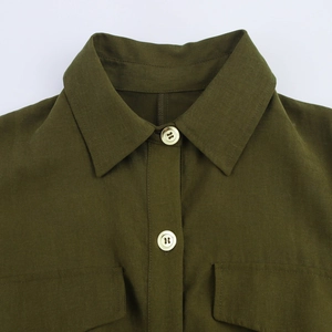 Detail of army green shirt collar with beige buttons and chest pockets texture