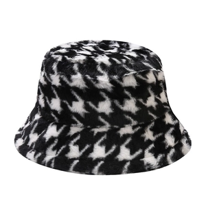 Classic black and white houndstooth plush bucket hat for winter warmth and fashion