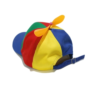 Detail of rainbow propeller hat showing adjustable blue strap and metal buckle clasp