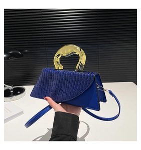 Deep blue faux crocodile handbag with gold metal handle and shoulder strap detail