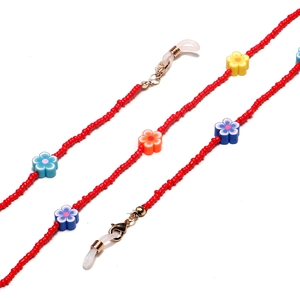 Detail of red beaded eyeglass chain with colorful clay flowers and golden lobster clasps