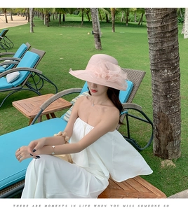 Pink wide brim beach hat with floral detail and summer sun protection