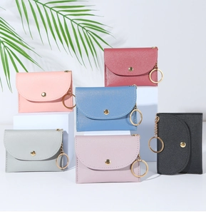 Close-up of colorful PU leather coin purses with gold keyrings and snap buttons