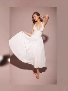 French style deep V-neck halter dress in white with pleated waist and flowing large hemline