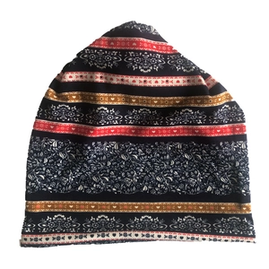 Close-up of heart and floral paisley patterns on a multi-color ethnic slouchy beanie